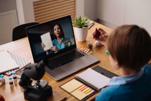 preteen-boy-uses-laptop-make-video-call-with-his-teacher