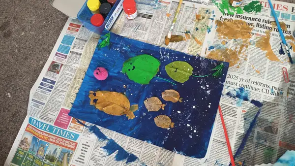 A painting of fish on a deep blue sea, made at the Art Fest