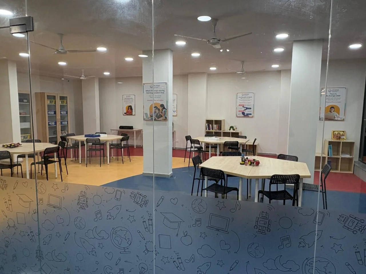 Work tables, shelves and kit cabinets seen through the doodle-printed glass