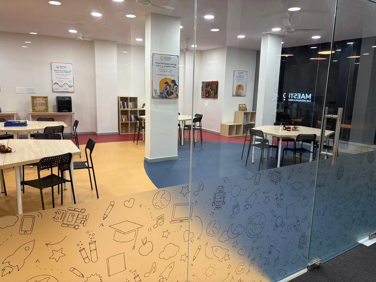 Looking into the Learning Garage through its glass wall, printed with maker doodles