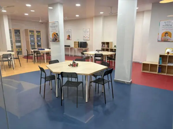 The bright Learning Garage room, with worktables, chairs and shelves of kits
