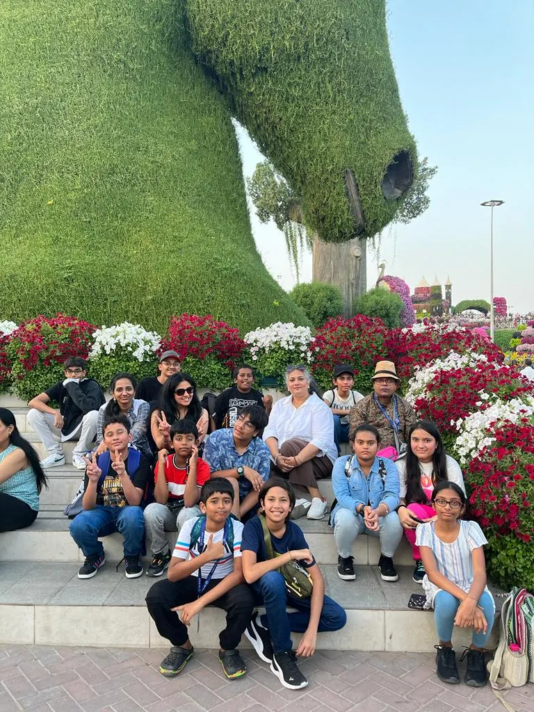 Learners and parents together in a flower garden on a 21K School trip
