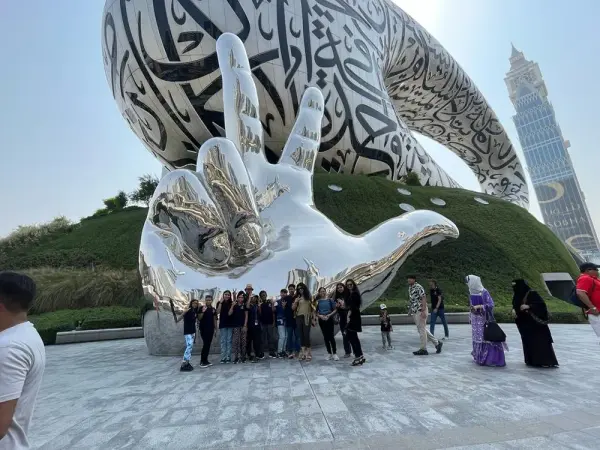 Learners in front of a large sculpture outside the Museum of the Future in Dubai