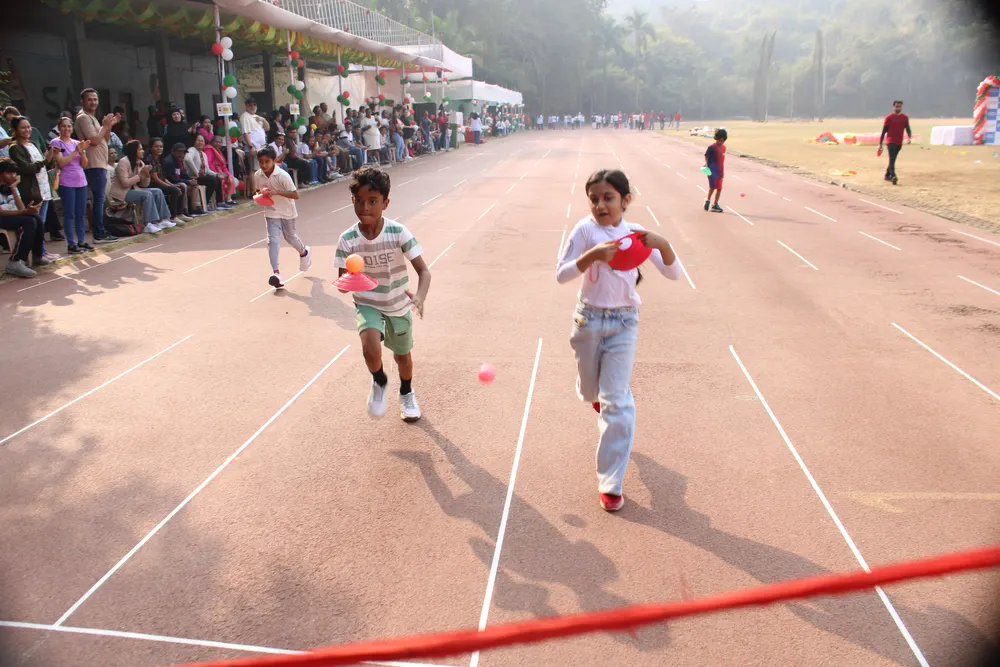 Two learners racing down the track at the Mumbai Sports Day