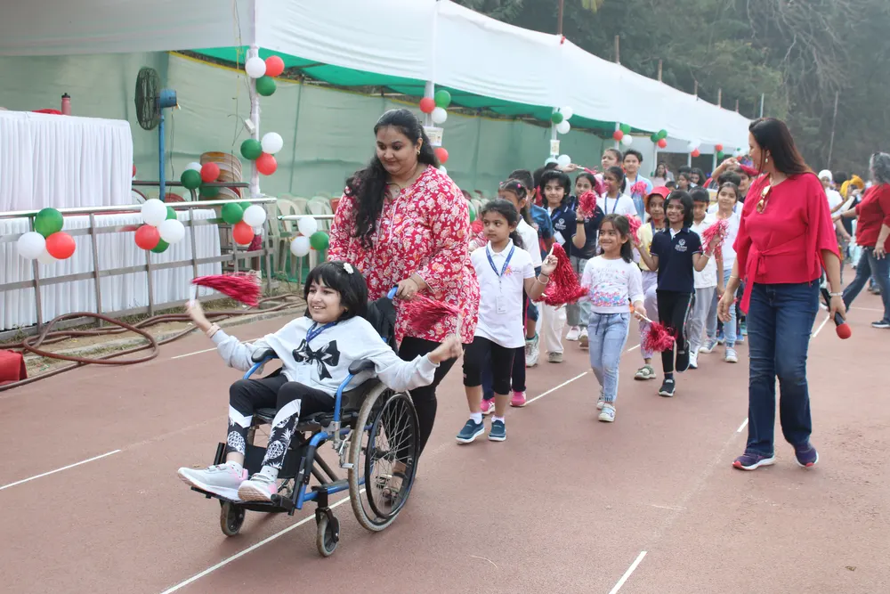 Learners and parents at a 21K School Sports Day, one learner in a wheelchair at the front