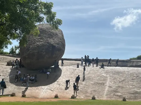 Learners exploring the rock slope below the giant balanced boulder at Mahabalipuram
