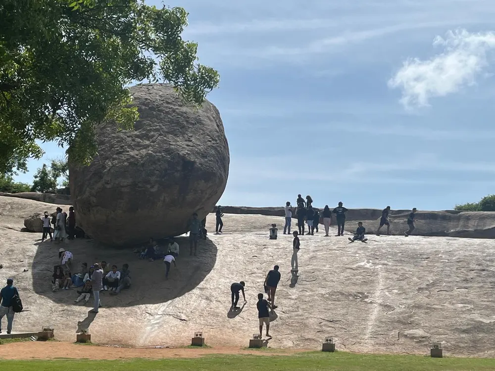 21K learners on a school trip beside the balancing boulder at Mahabalipuram