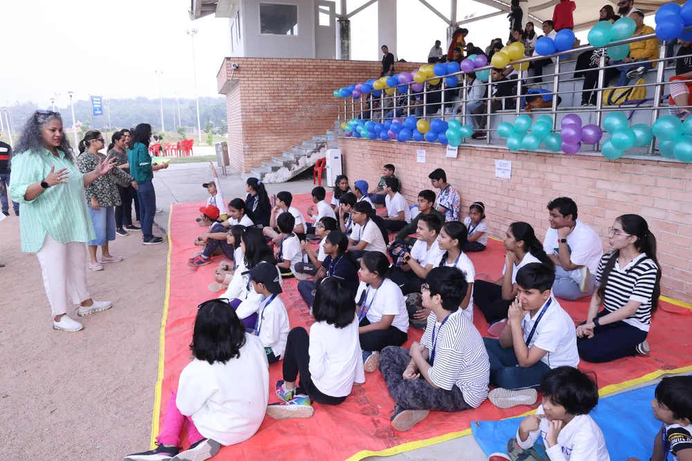 Learners sitting together on mats at a 21K School event