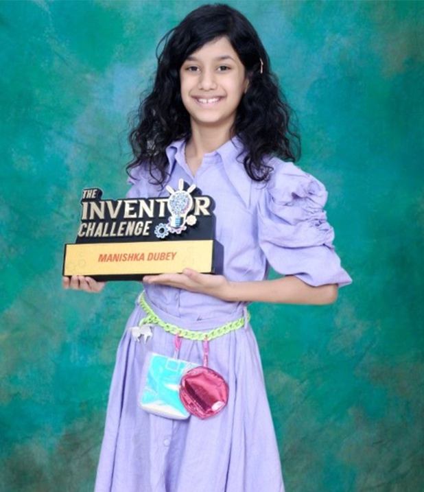 Manishka Dubey holding her Inventor Challenge trophy