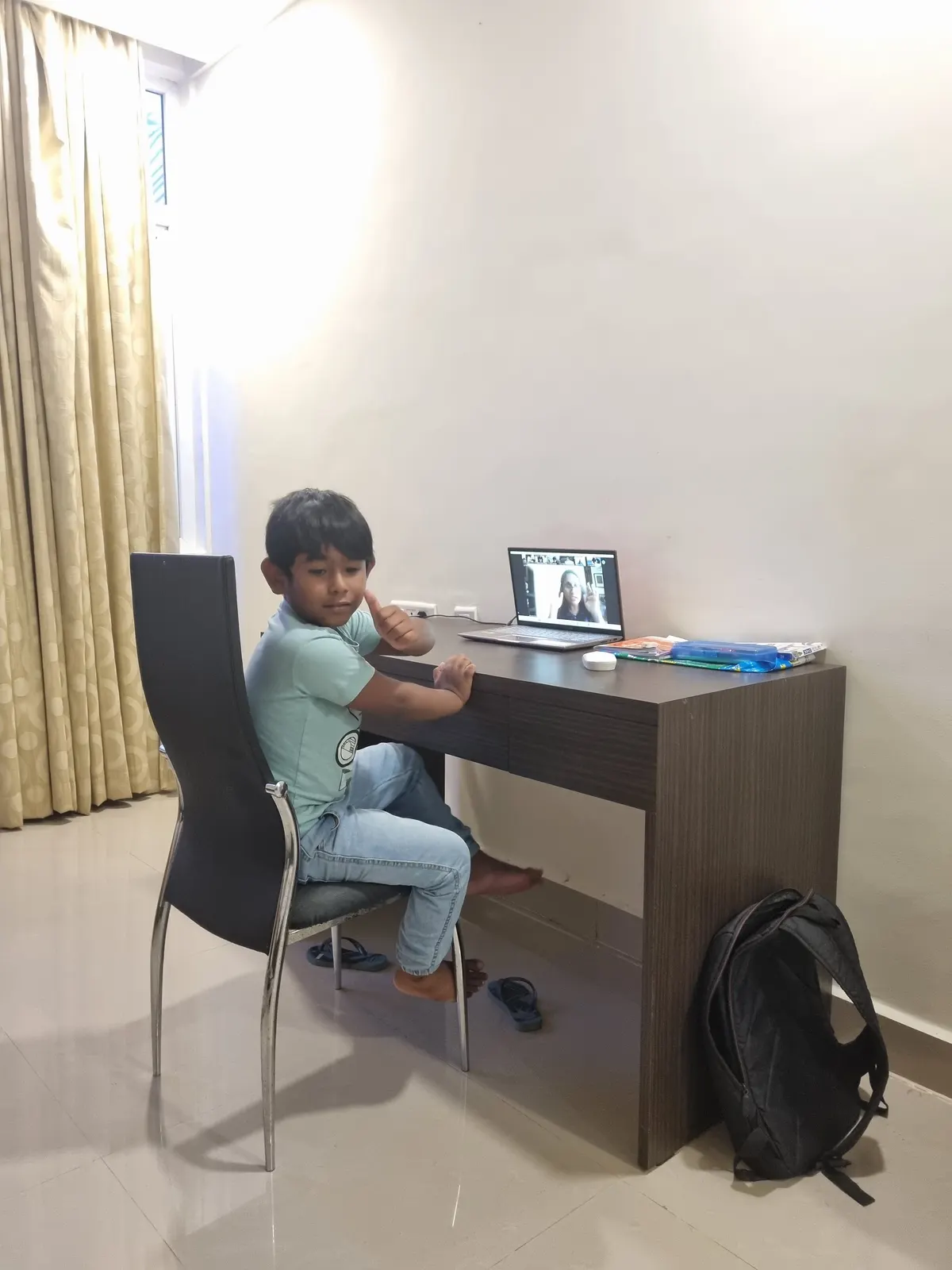A learner at a quiet home desk with a laptop open for a live class