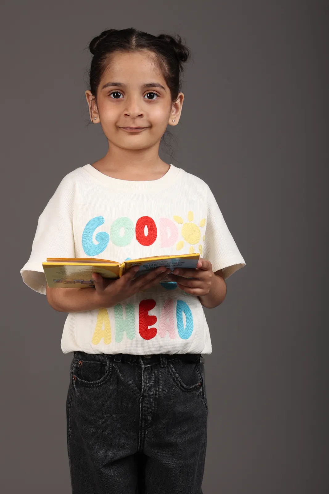 A young child holding an open picture book