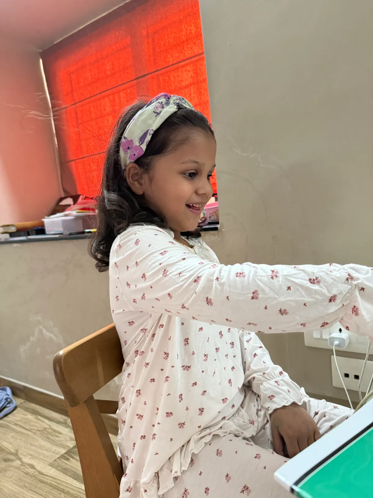 A learner at a laptop at home