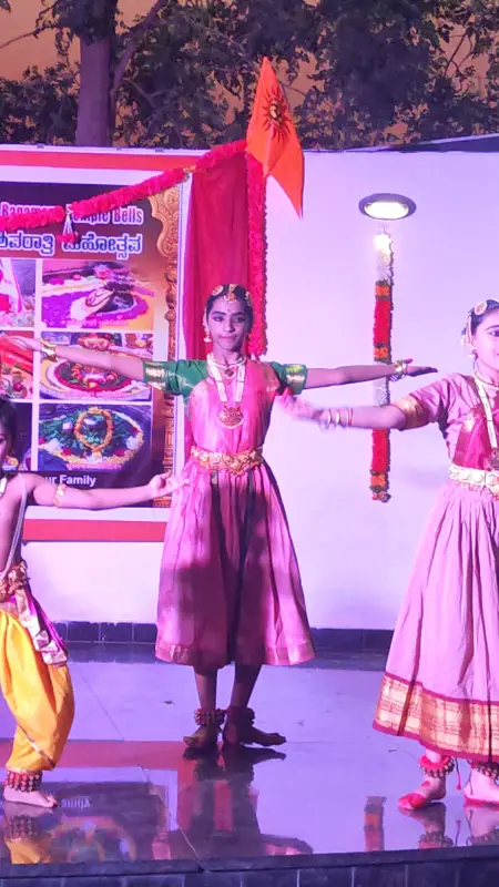 Learners performing a dance on a colourful lit stage