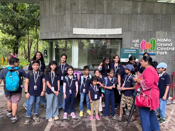 Learners in 21K School polos and lanyards gathered together on a city field trip