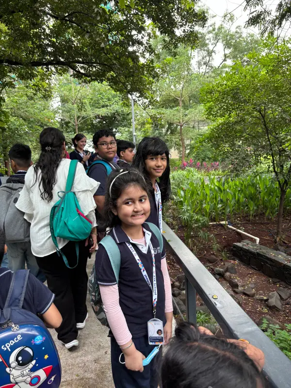 Learners with backpacks on a garden path during a field trip