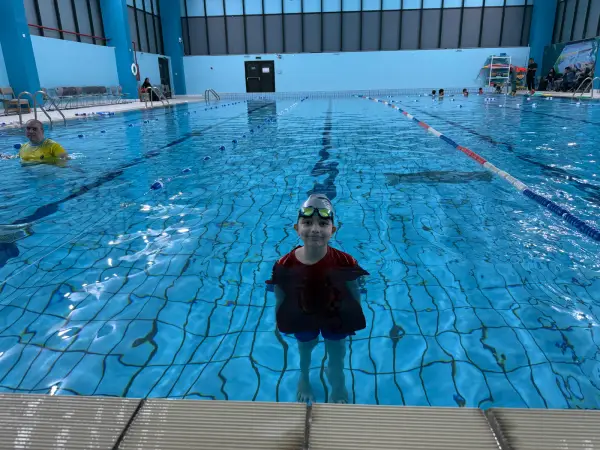 A learner swimming in a lane pool