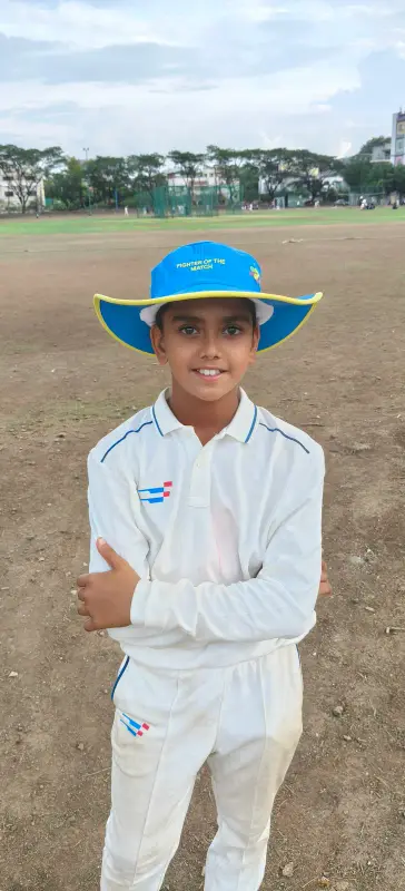A learner in cricket whites on the field