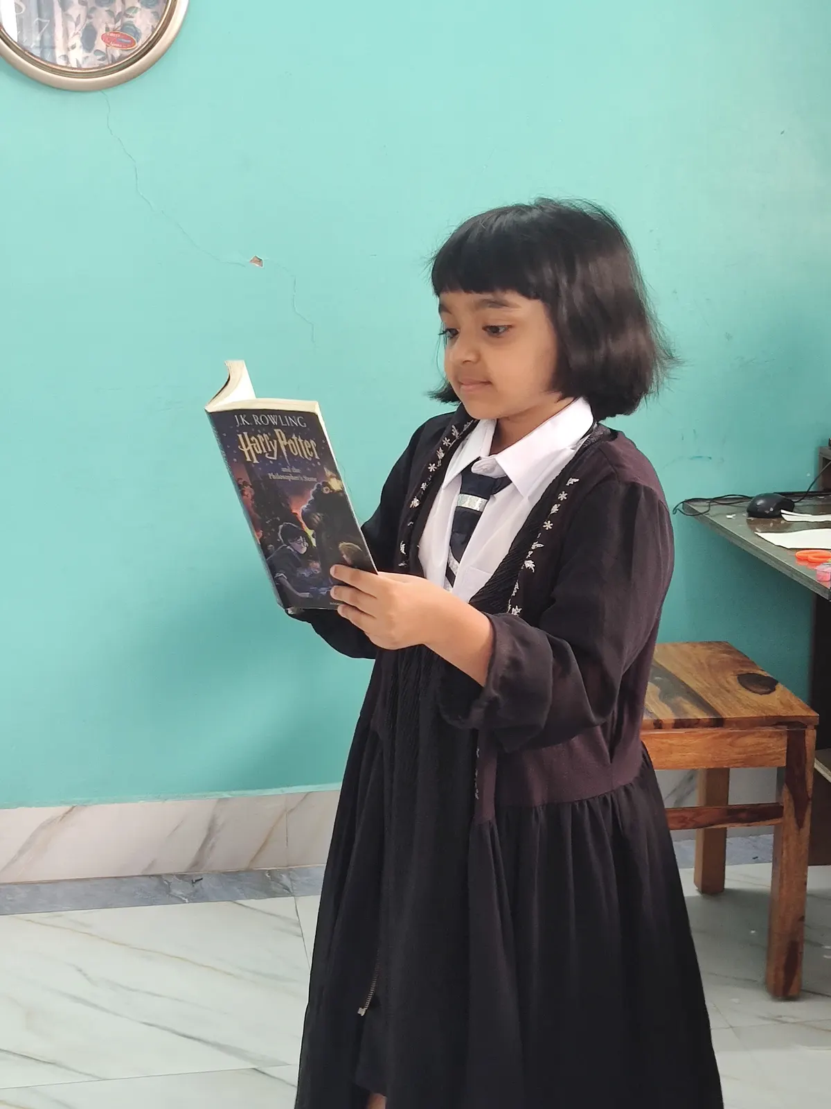 A learner reading a book at home