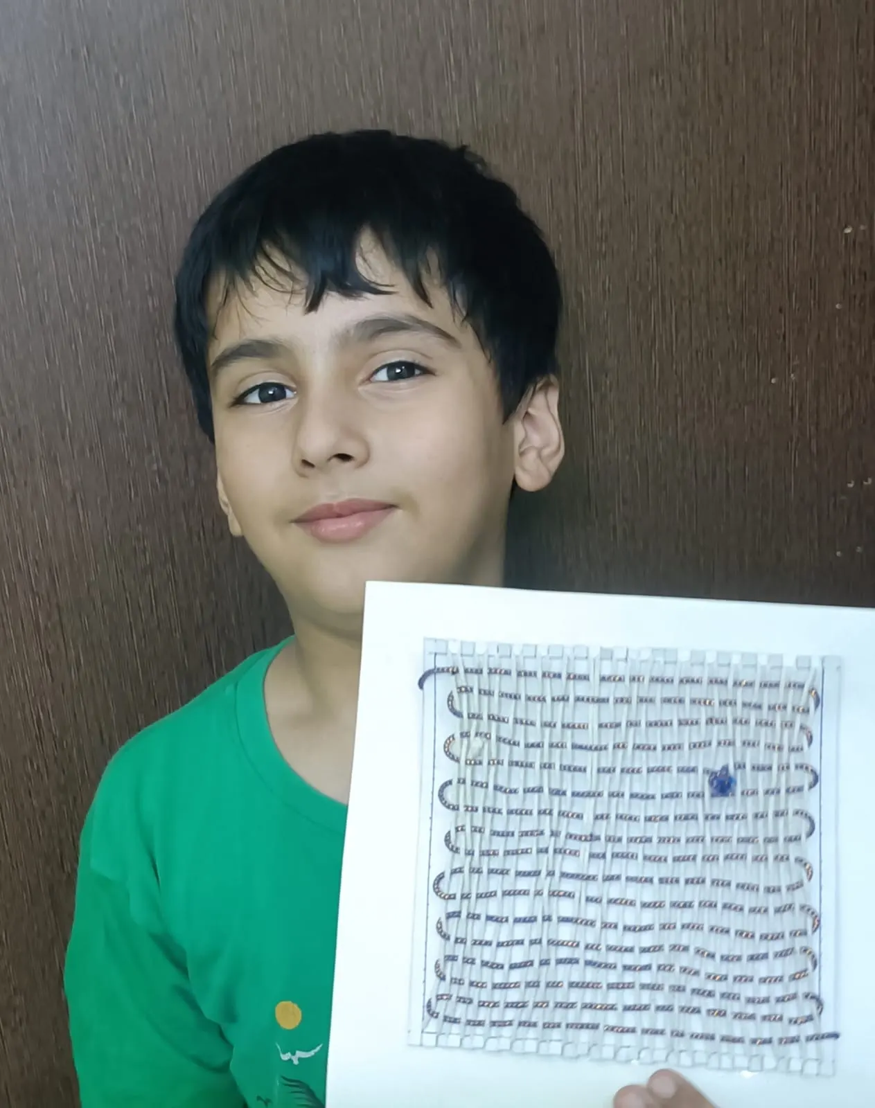 A learner holding up a page of his own handwriting
