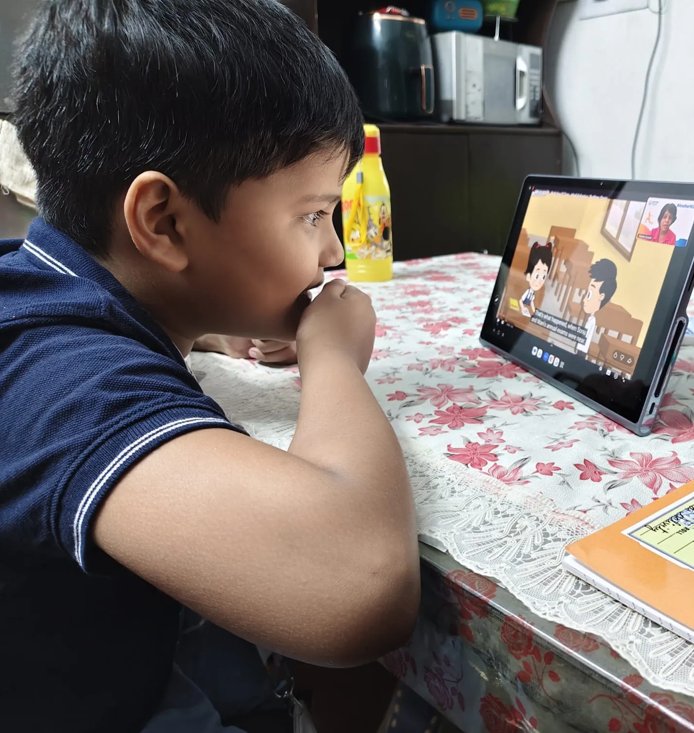 A learner following a lesson on a tablet at home