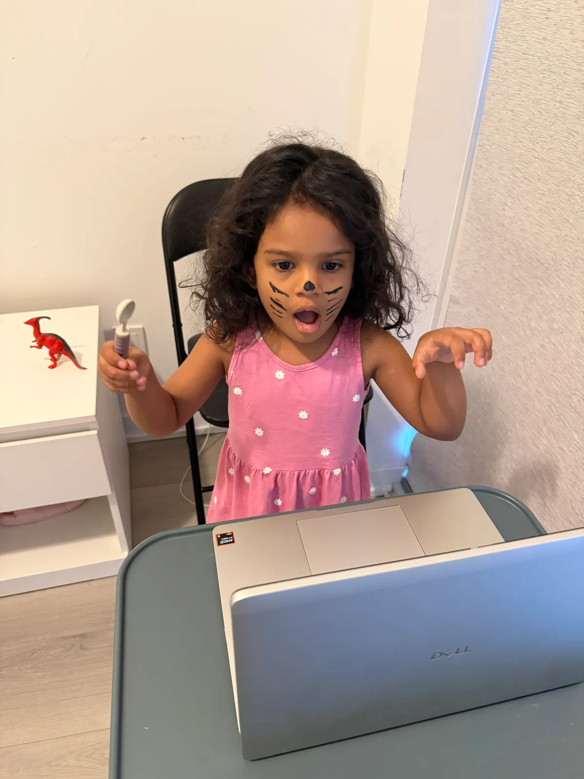 A young learner in a live online class at her laptop