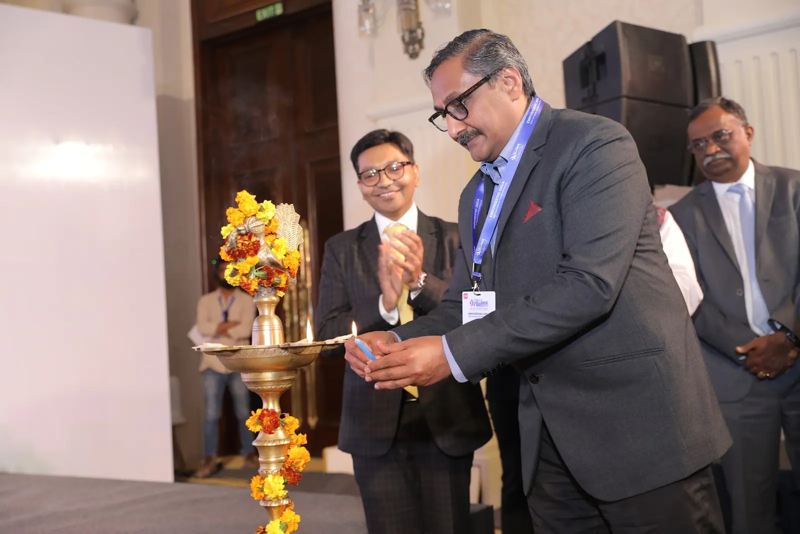 Guests light the ceremonial lamp to open the Right to Excellence summit