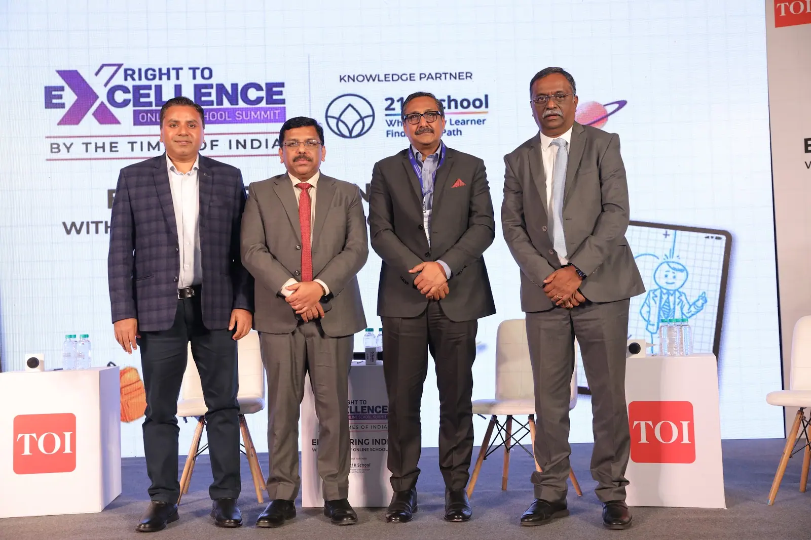 The panel’s speakers stand together on stage after their session