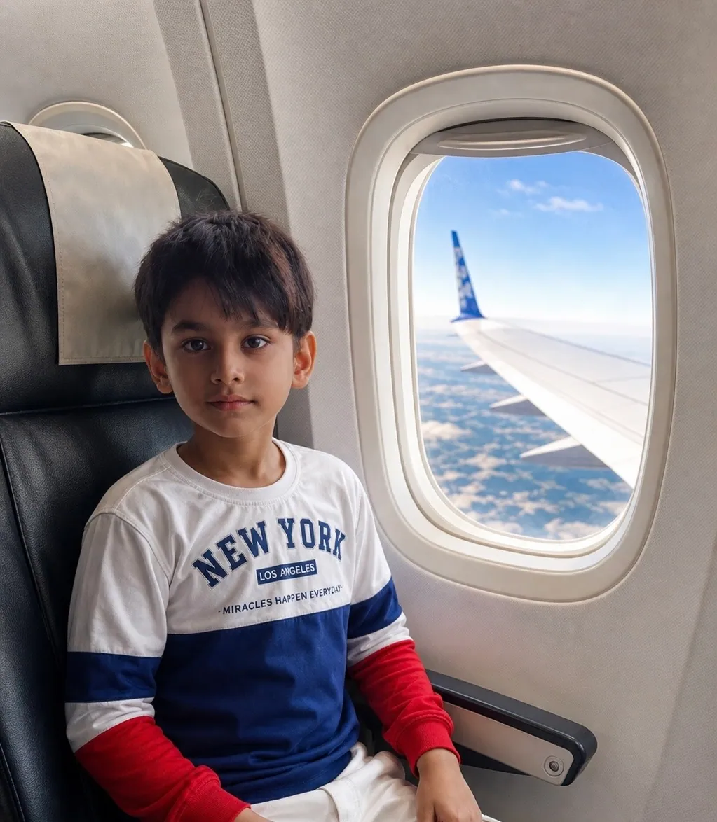 A young learner in a plane window seat, with the wing and clouds outside