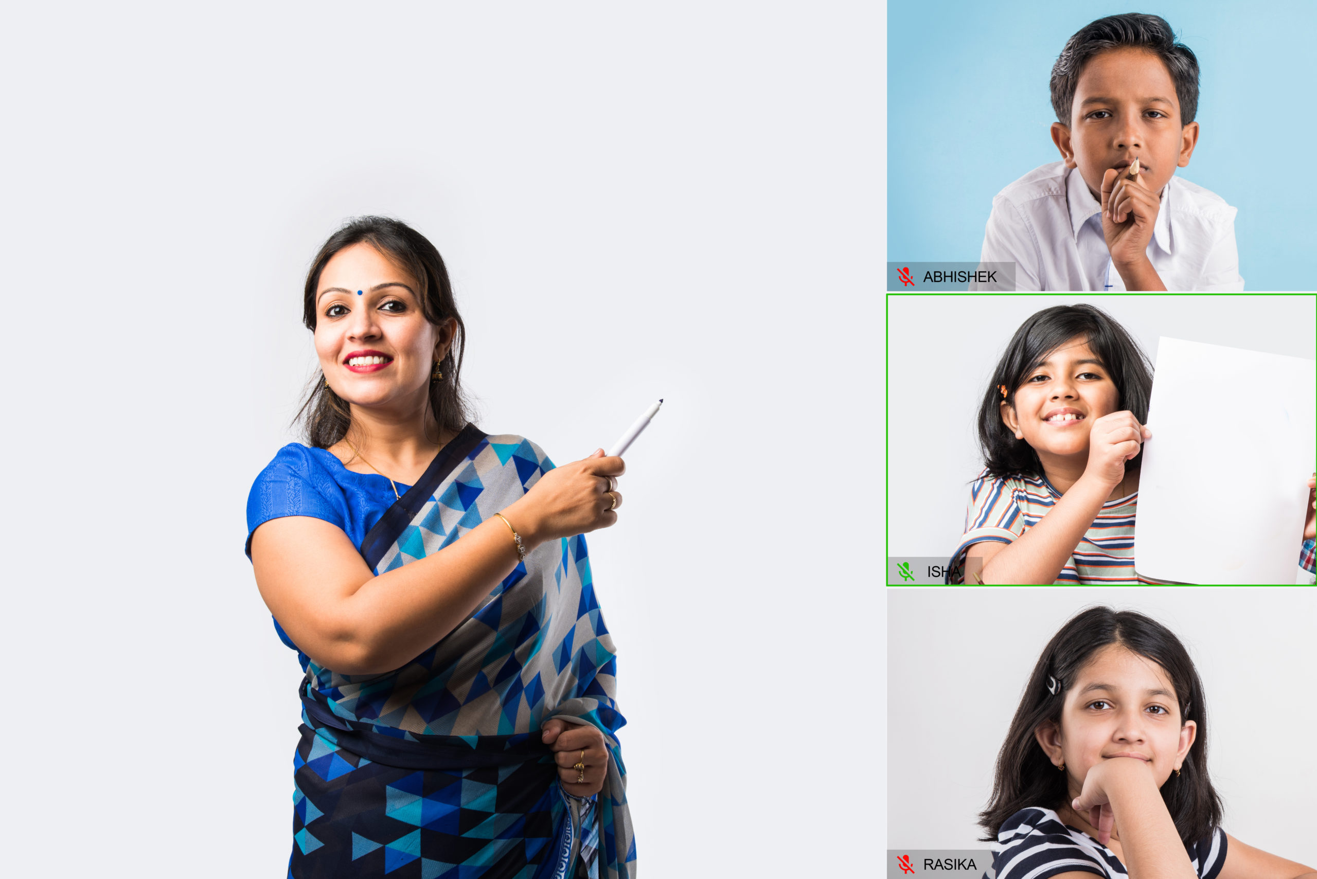 Portrait of asian Indian lady teacher in saree stands against writing board conducting online class